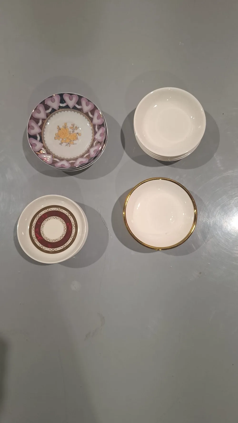 Four designs of small coffee saucers stacked