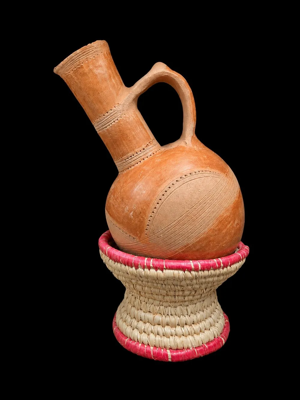 Terracotta Eritrean jebena on a colourful woven ring stand