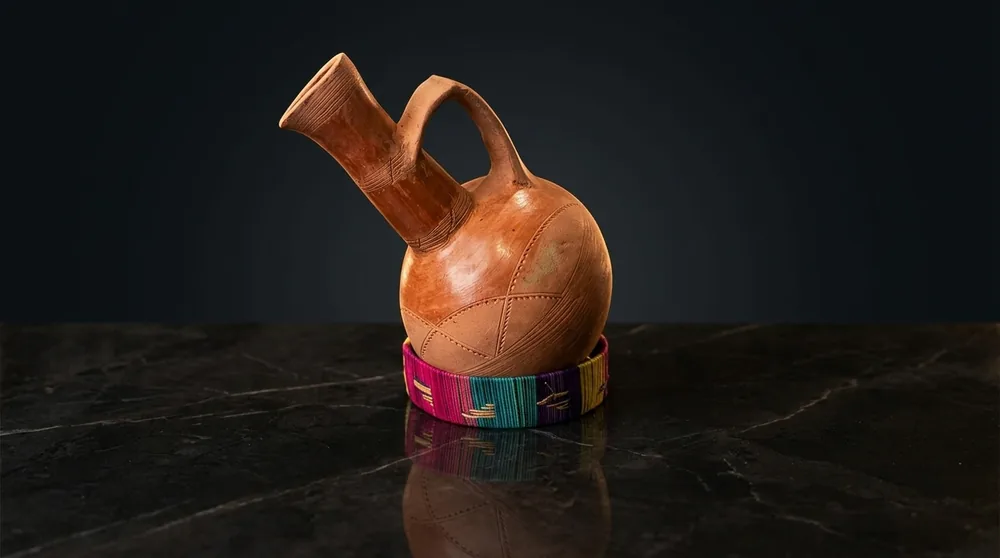Black glazed Ethiopian jebena coffee pot with long neck and side spout